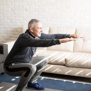 Mature man doing squats workout at home mature man doing squats workout at home