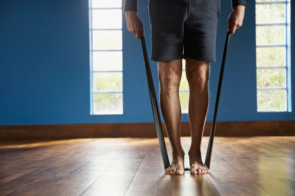 mature man exercising with resistance band