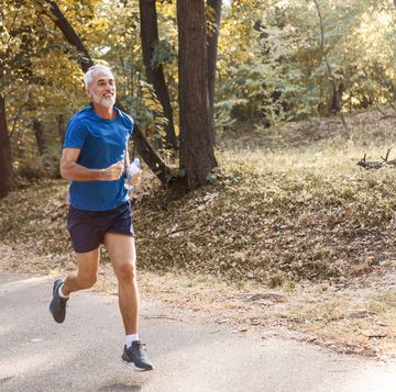 mature man exercising with water bottle