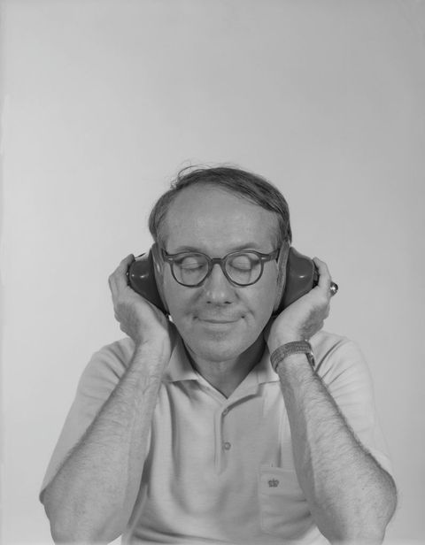 mature man listening music with headphones