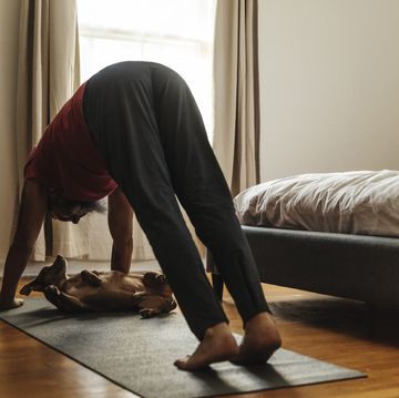 mature man practicing yoga in bedroom