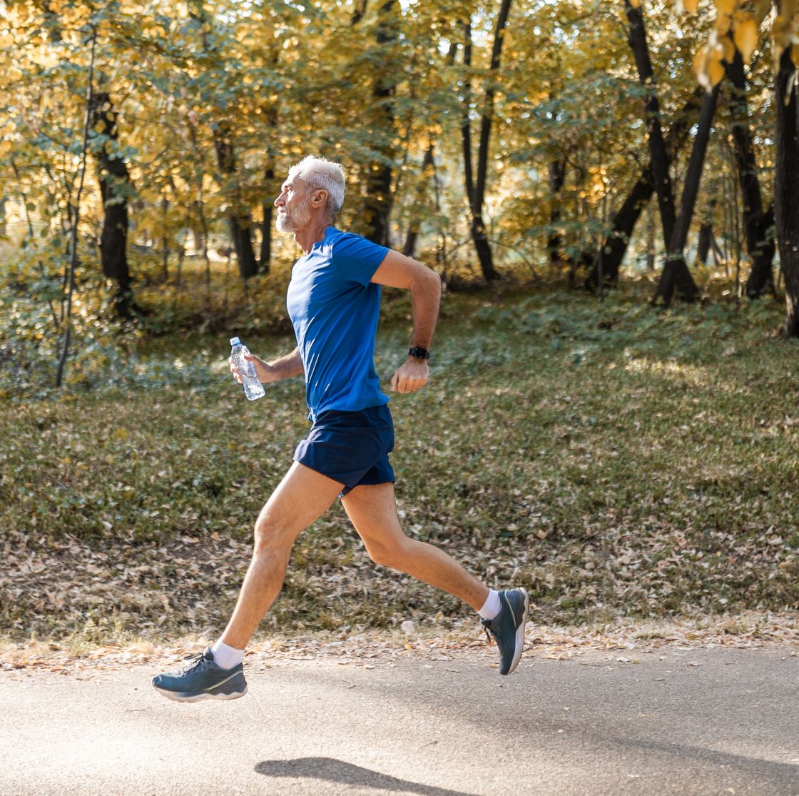 mature man running through the park