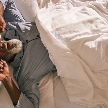 mature man wakes in bed