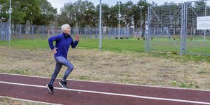 Mature Sporty Woman Jogging in Public Park