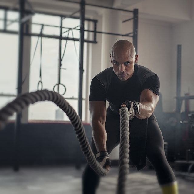 mature strong man battling with rope