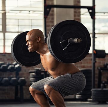 mature strong man lifting weights at cross training