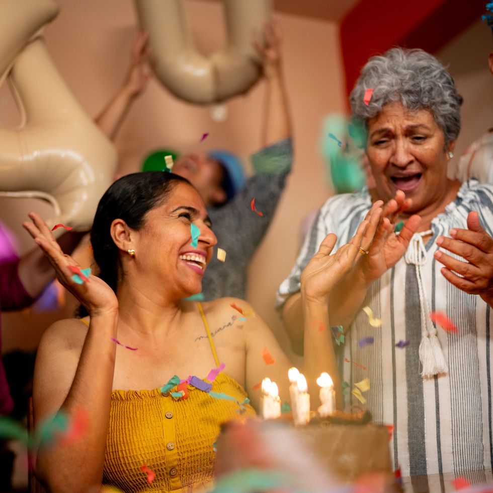 woman celebrating birthday with family at home