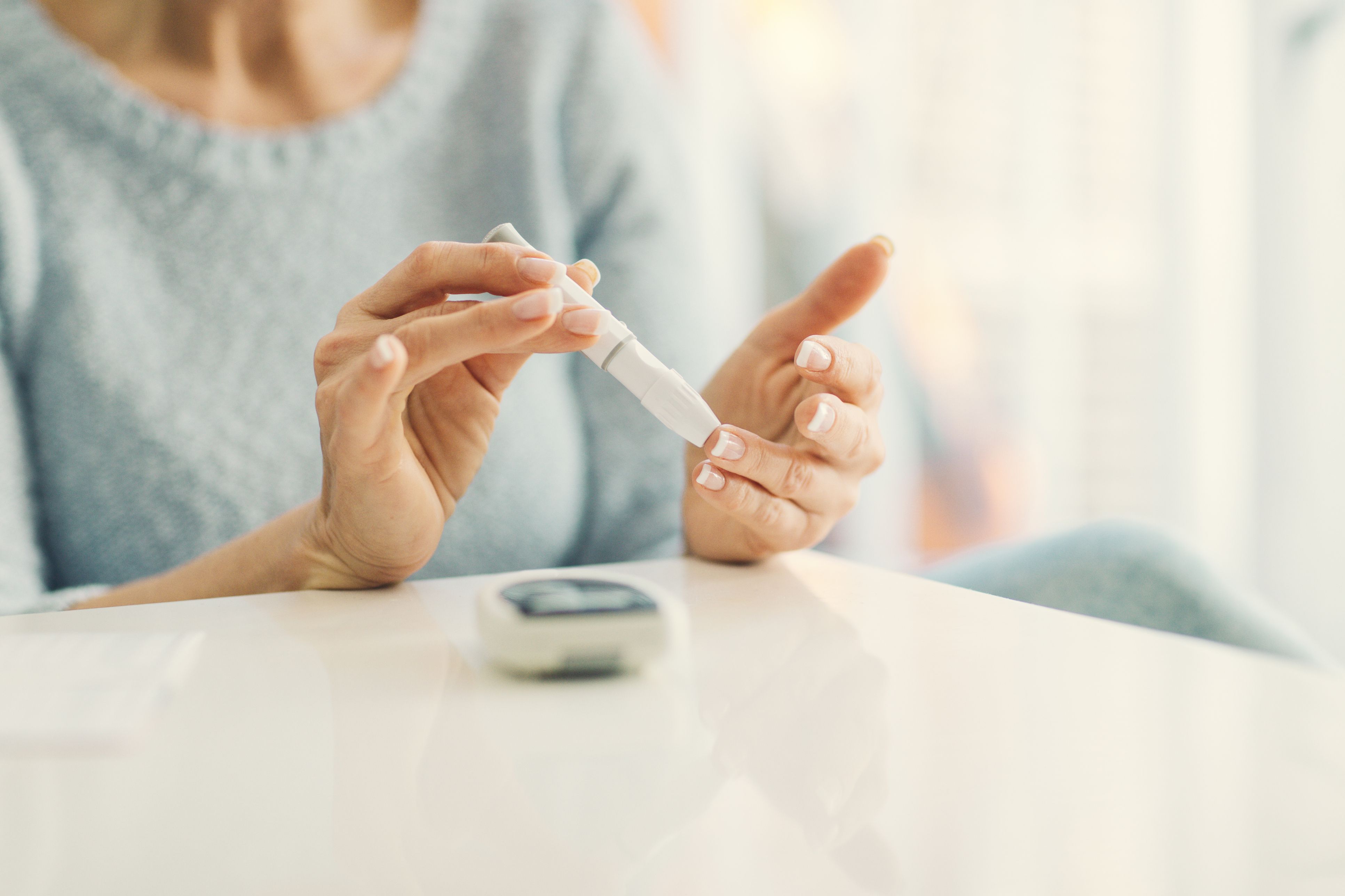 Mature Woman Doing Blood Sugar Test at home.