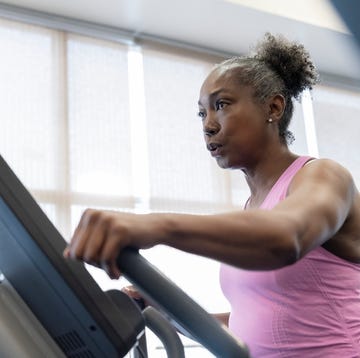 Mature woman exercising on elliptical machine mature woman exercising on elliptical machine