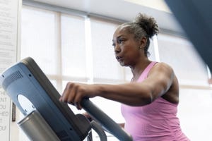 mature woman exercising on elliptical machine