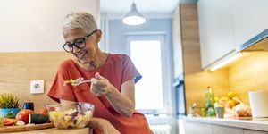 mature woman having salad for lunch