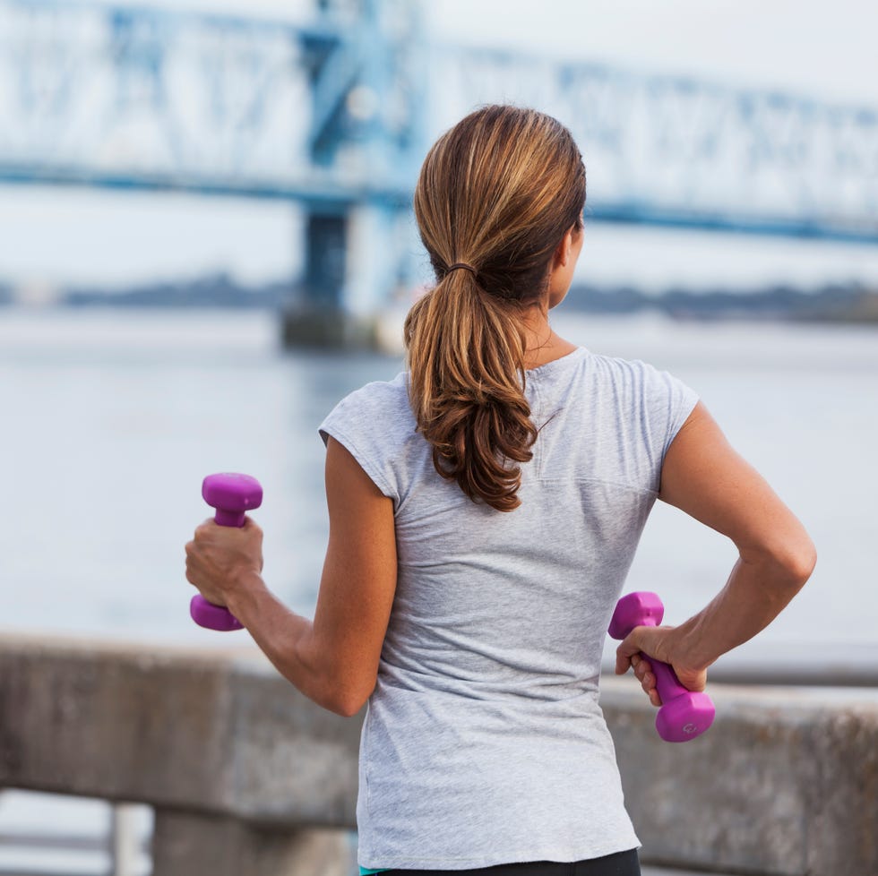 mature woman jogging or power walking on waterfront