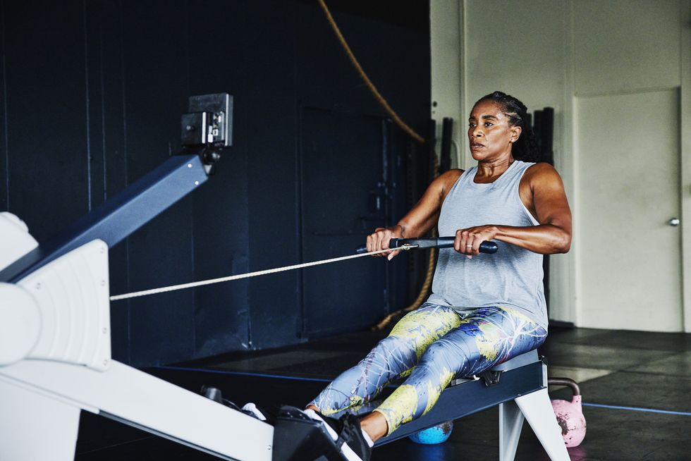 mature woman on rowing machine during workout in gym