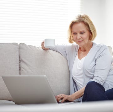 Woman relaxing on sofa using laptop How to delete your gmail account