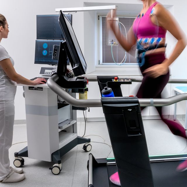 mature woman running on a treadmill and taking a cardio stress test