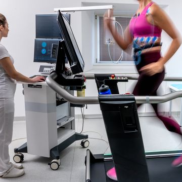 mature woman running on a treadmill and taking a cardio stress test