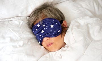 mature woman sleeping in bed with eye mask close u