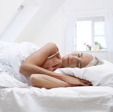 mature woman sleeping in her bed