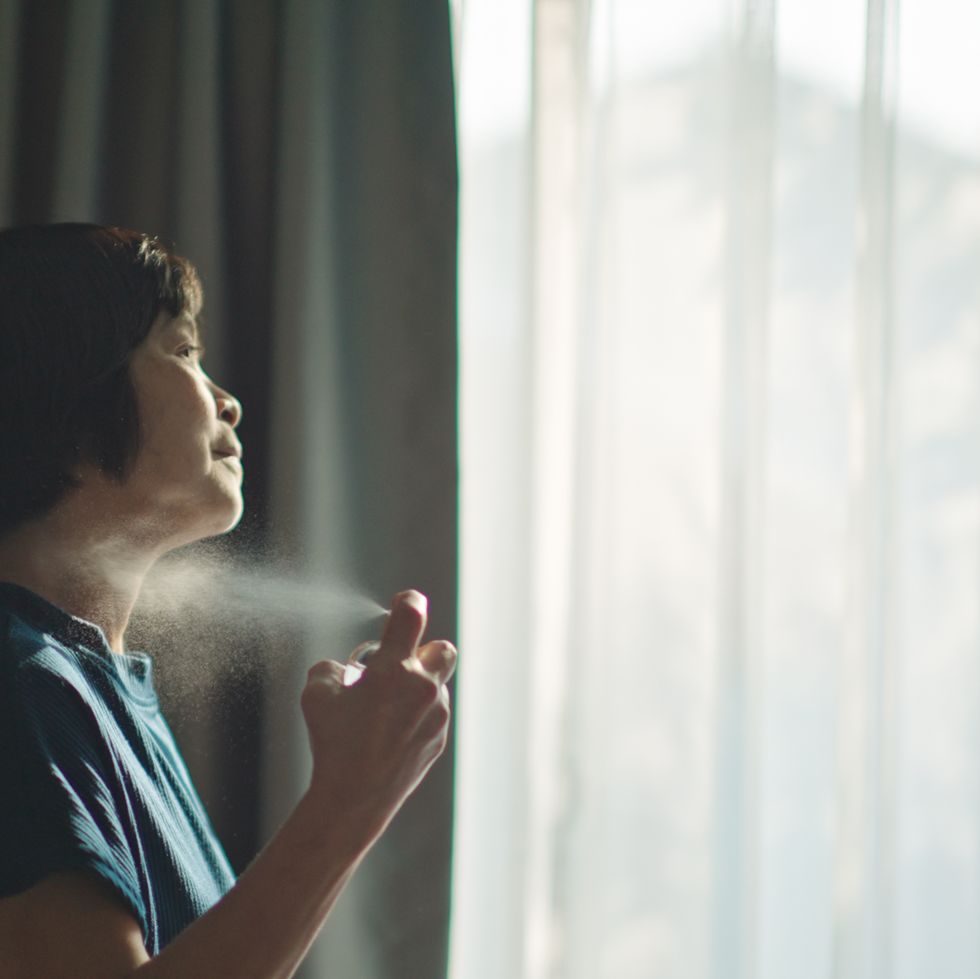 mature woman using perfume