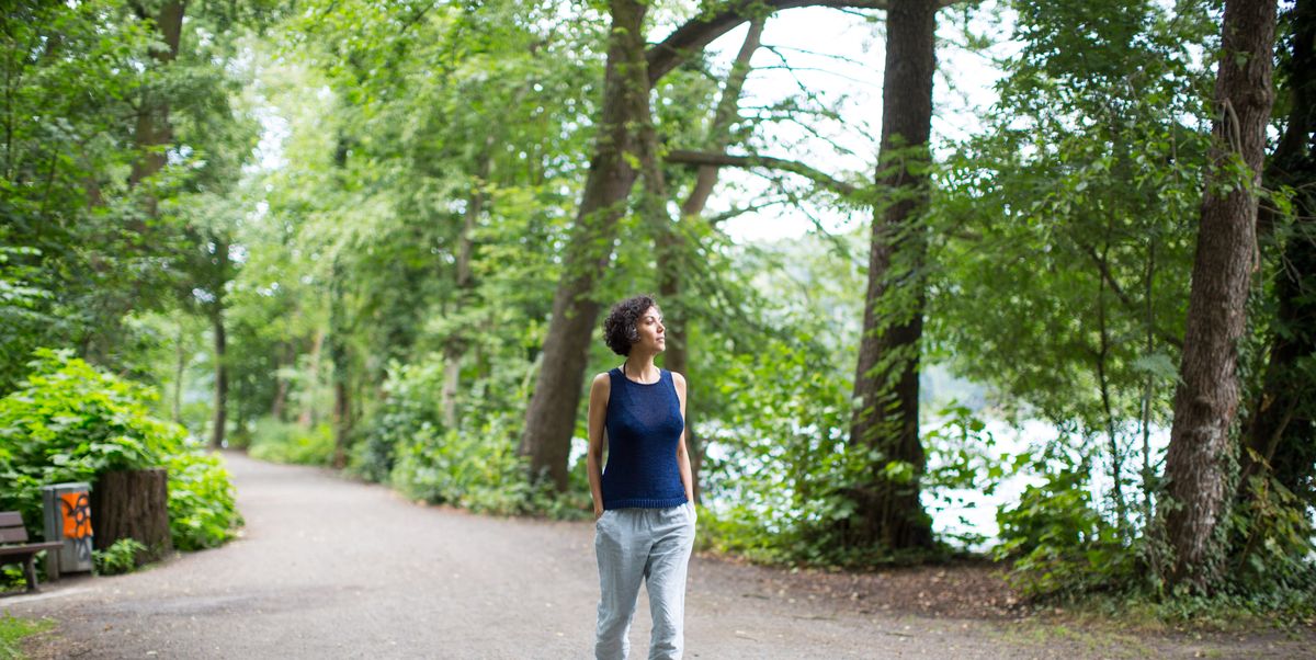 https://hips.hearstapps.com/hmg-prod/images/mature-woman-walking-on-road-in-forest-royalty-free-image-1755804315.pjpeg?crop=1.00xw:0.752xh;0,0.113xh&resize=1200:*