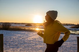 woman running in the winter snow