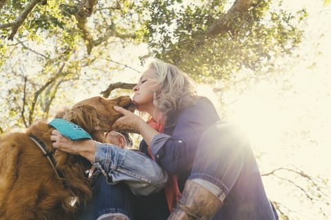 mature woman with dog on sunny day