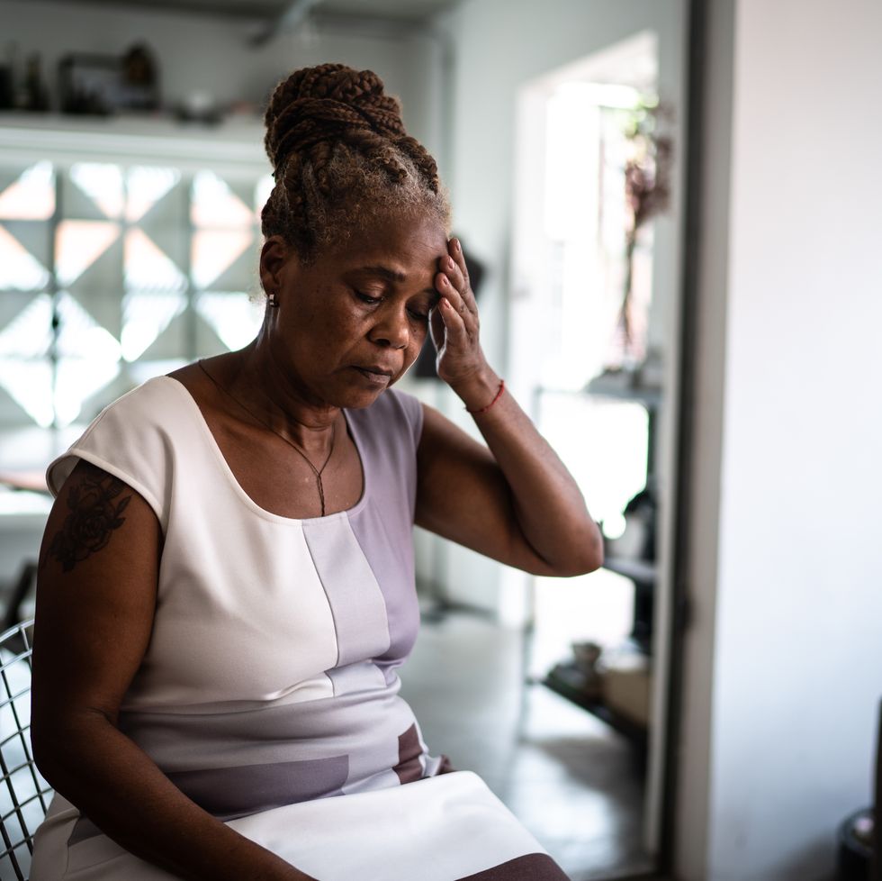 mature woman with headache at home