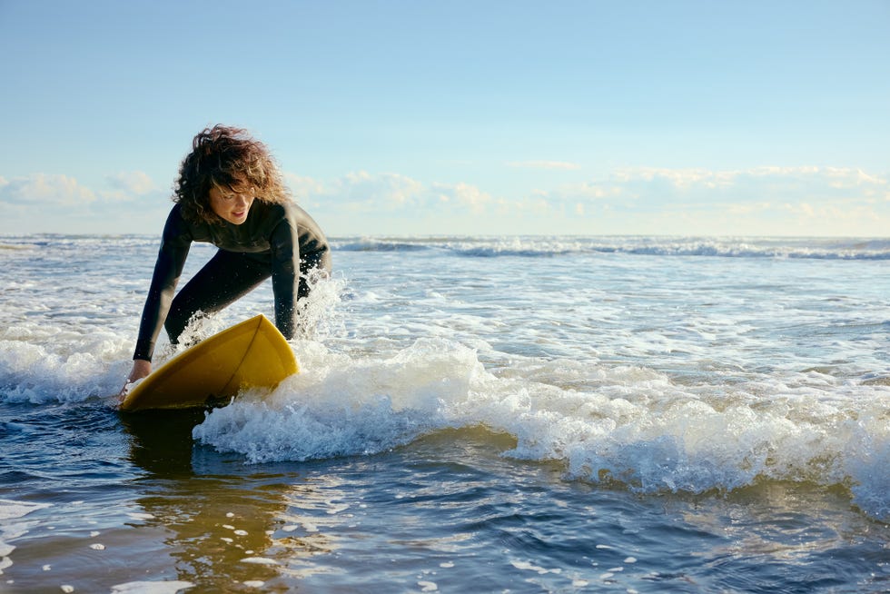 mature young mother rides early morning wave