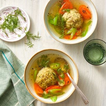 matzo ball soup in a bowl with carrots and celery