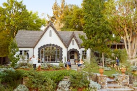 a white tudor style house with gray trim