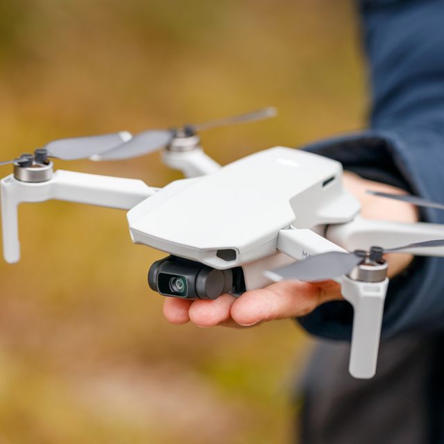 dji mavic mini drone quadcopter in hand man close up
