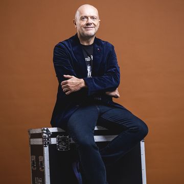 a man sitting on a suitcase