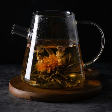 a glass mug with a plant in it
