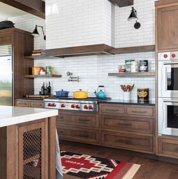 a modern farmhouse kitchen with stained wood cabinets and drawers