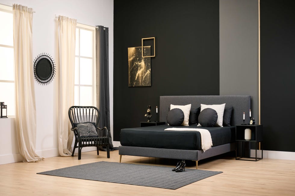 a bedroom with a bed and a chair