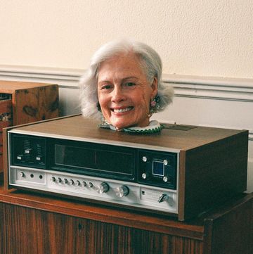 a person smiling behind a radio