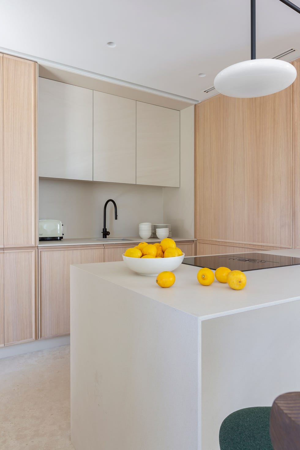 cocina con muebles de madera, península y taburetes