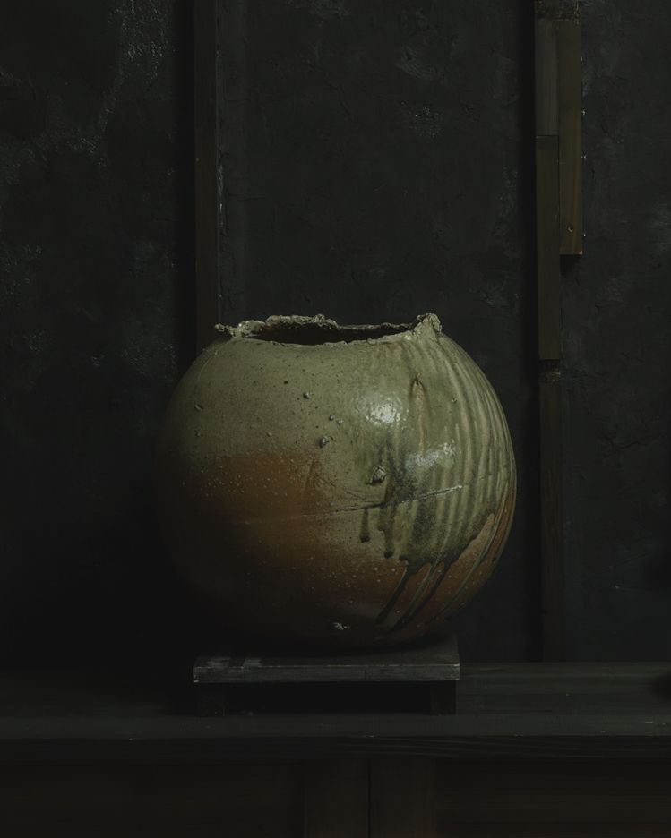 a vase sits on a shelf