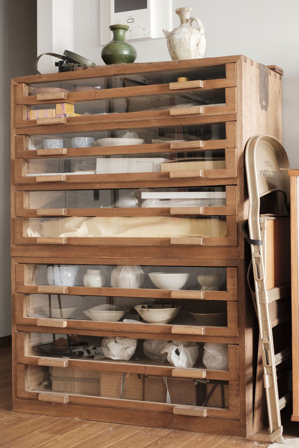 a wooden shelving unit with white cats and white cats