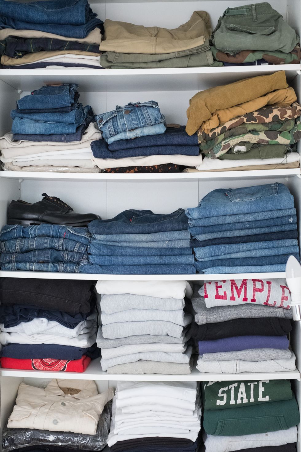 a group of clothes on shelves