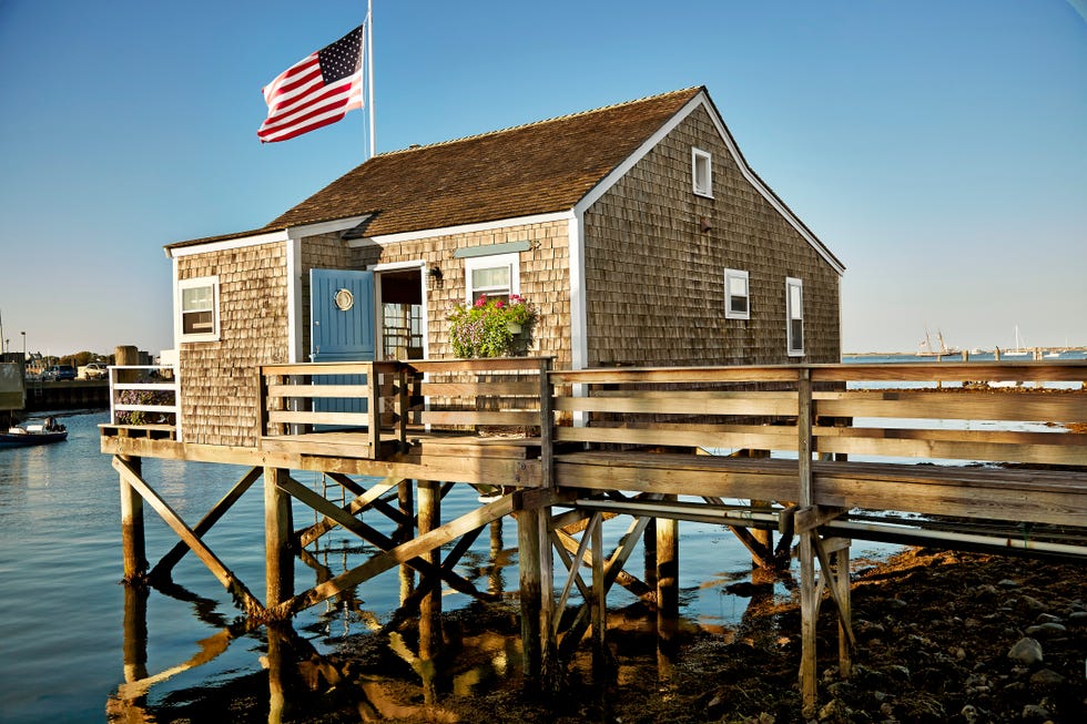 shingled cottage on pier over water