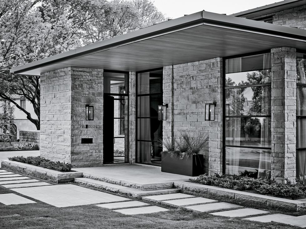 a black and white exterior image of a midcentury modern new build