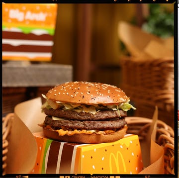Mcdonald's new burger launch a person holding a large burger in a food event setting