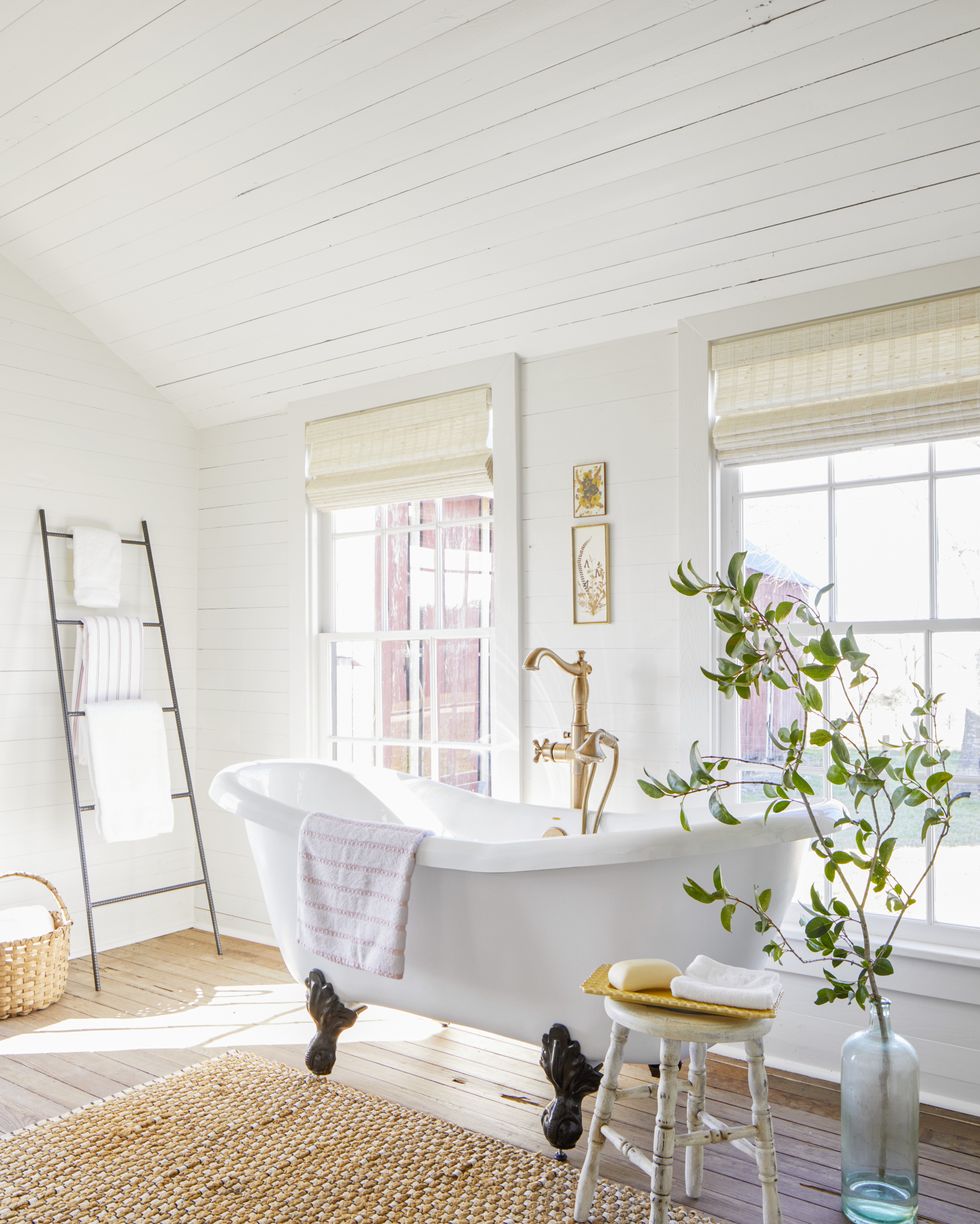 white farmhouse bathroom with clawfoot bathtub