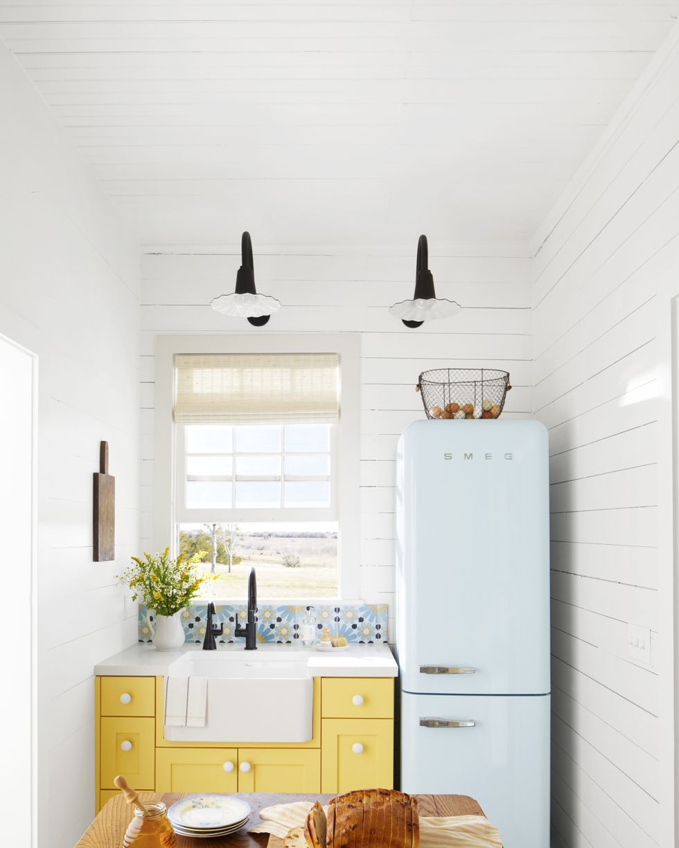 tiny kitchen with yellow cabinetry