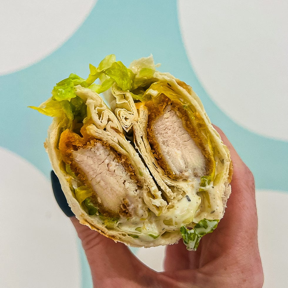 crosssection of a wrapped sandwich featuring fried chicken and lettuce