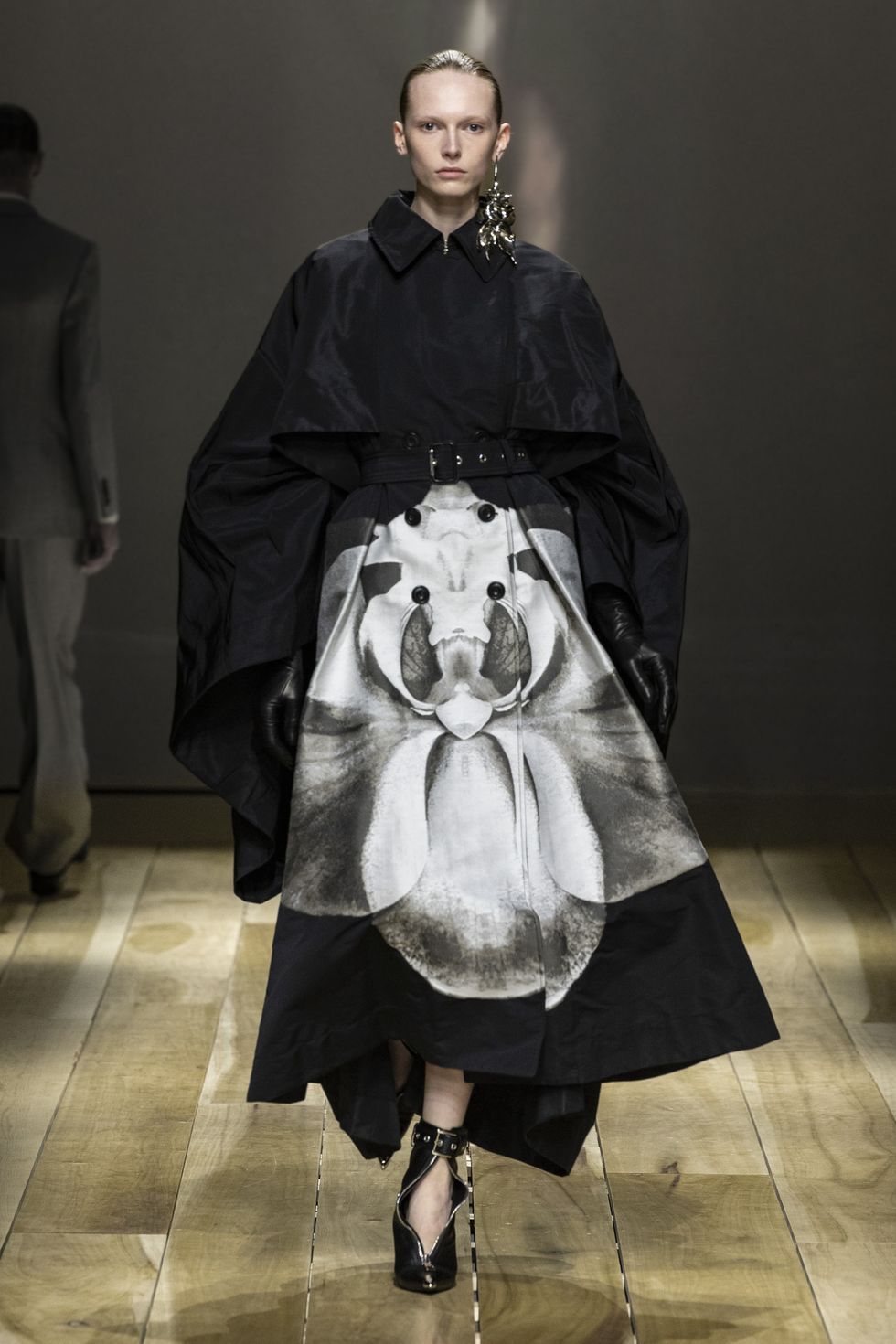a black coat printed with a white botanical motif from mcqueen fall 2023