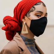 This is an image woman with red scarf and black face mask