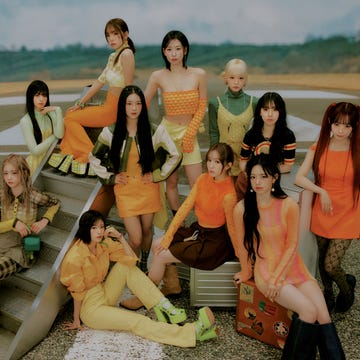 a group of women posing for a photo on a beach