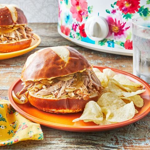 slow cooker pulled pork on bun with chips